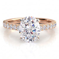 Rose gold diamond engagement ring with a large oval center stone and small diamonds along the shoulders, shown on a clean white background.