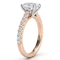 A rose gold engagement ring featuring a large oval-cut center stone in a four-prong setting, with a pavé band accented by small round stones, shown on a white background.