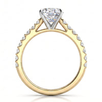 A two-tone diamond engagement ring featuring a yellow gold band with pavé-set round diamonds prong setting holding a large round brilliant-cut center stone, shown on a white background.