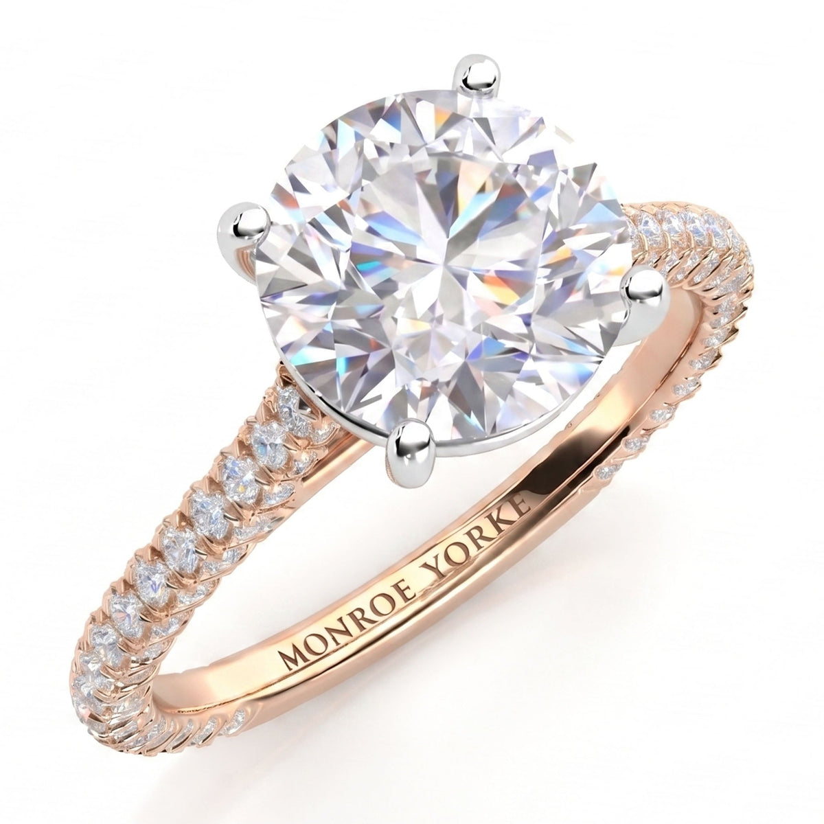 Elsie engagement ring in rose gold. Round brilliant centre diamond in a four claw setting, with pave diamonds set to three sides of the band.
