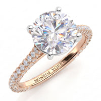Elsie engagement ring in rose gold. Round brilliant centre diamond in a four claw setting, with pave diamonds set to three sides of the band.