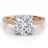 Elsie engagement ring in rose gold, showing the four claw centre setting and the pave-set band.