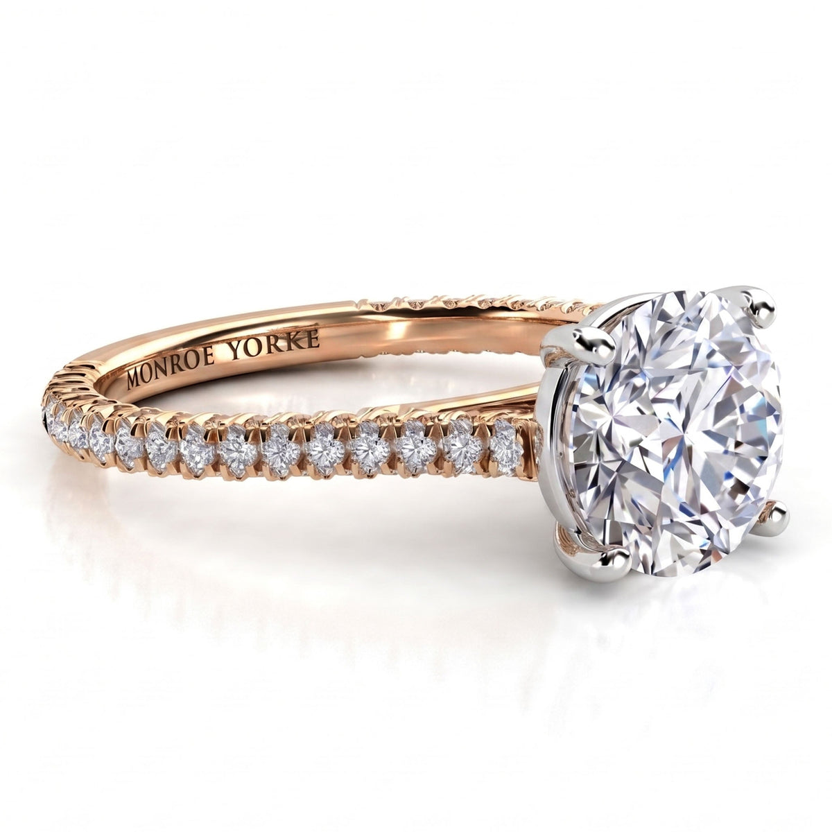 Elsie engagement ring in rose gold. Side view showing diamonds set to three sides of the band.