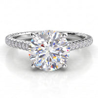 Elsie engagement ring in white gold or platinum, showing the four claw centre setting and the pave-set band.