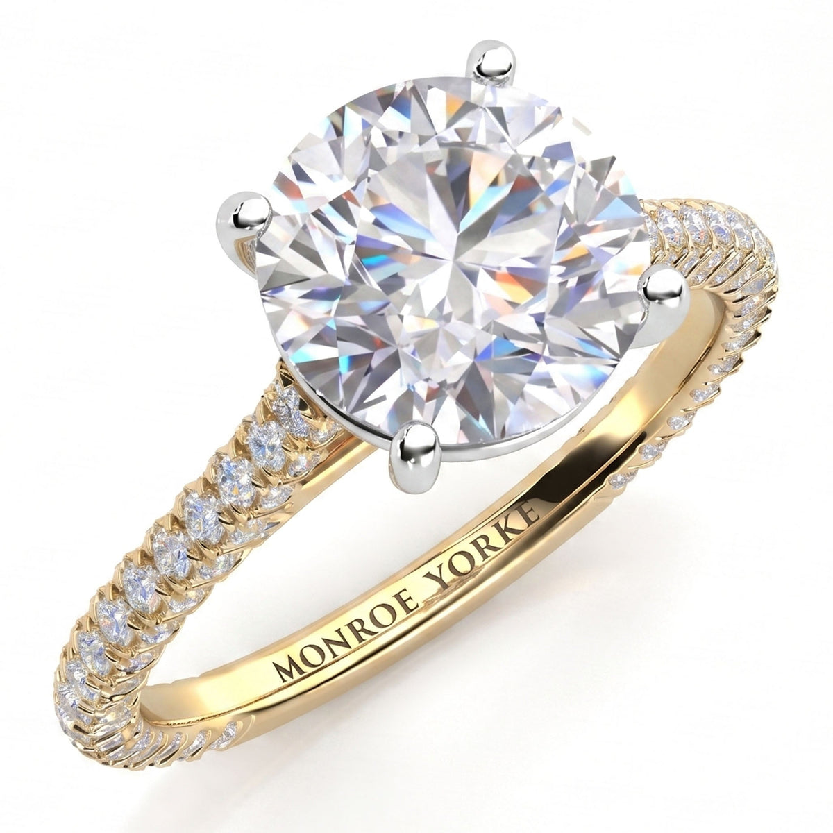 Elsie engagement ring in yellow gold. Round brilliant centre diamond in a four claw setting, with pave diamonds set to three sides of the band.