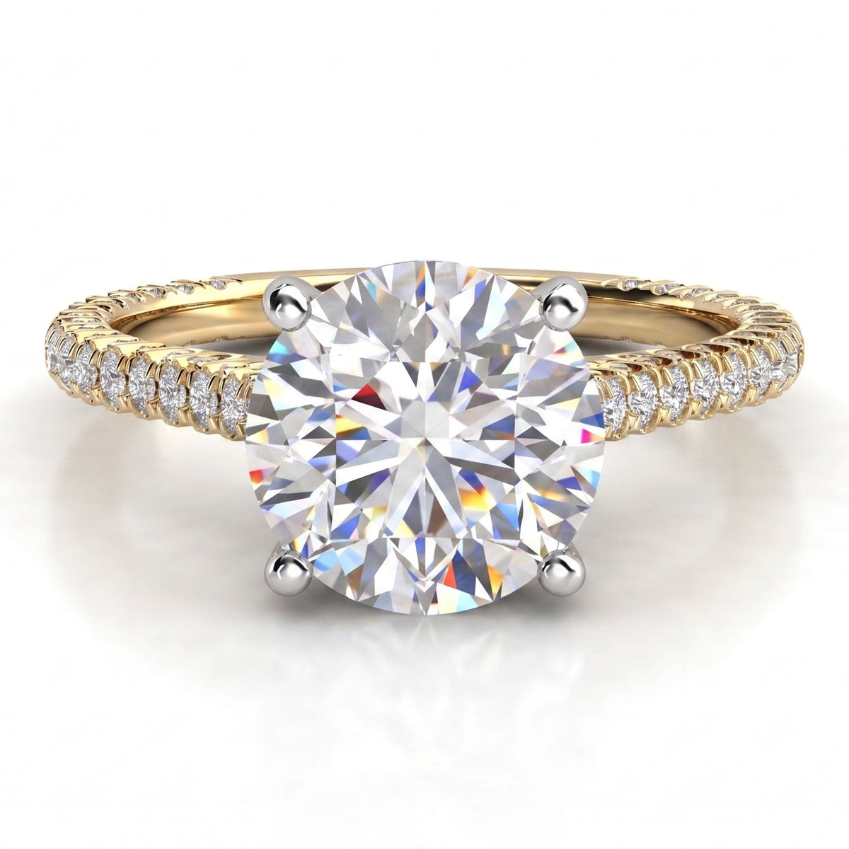 Elsie engagement ring in yellow gold, showing the four claw centre setting and the pave-set band.