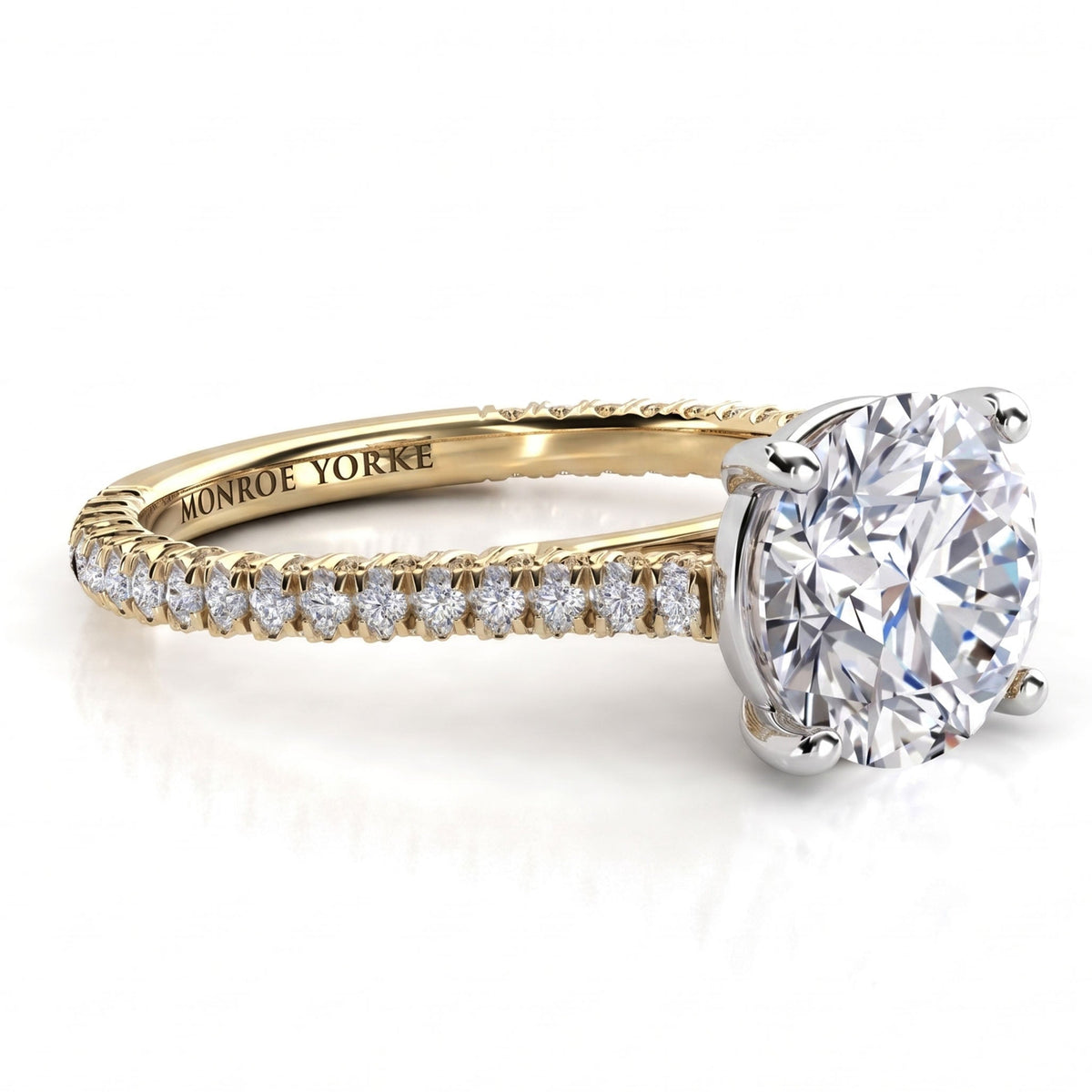 Elsie engagement ring in yellow gold. Side view showing diamonds set to three sides of the band.