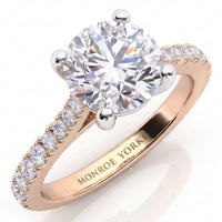 Enya rose gold engagement ring, close view of the round brilliant centre diamond and the diamond set band, Monroe Yorke engraved inside the band.