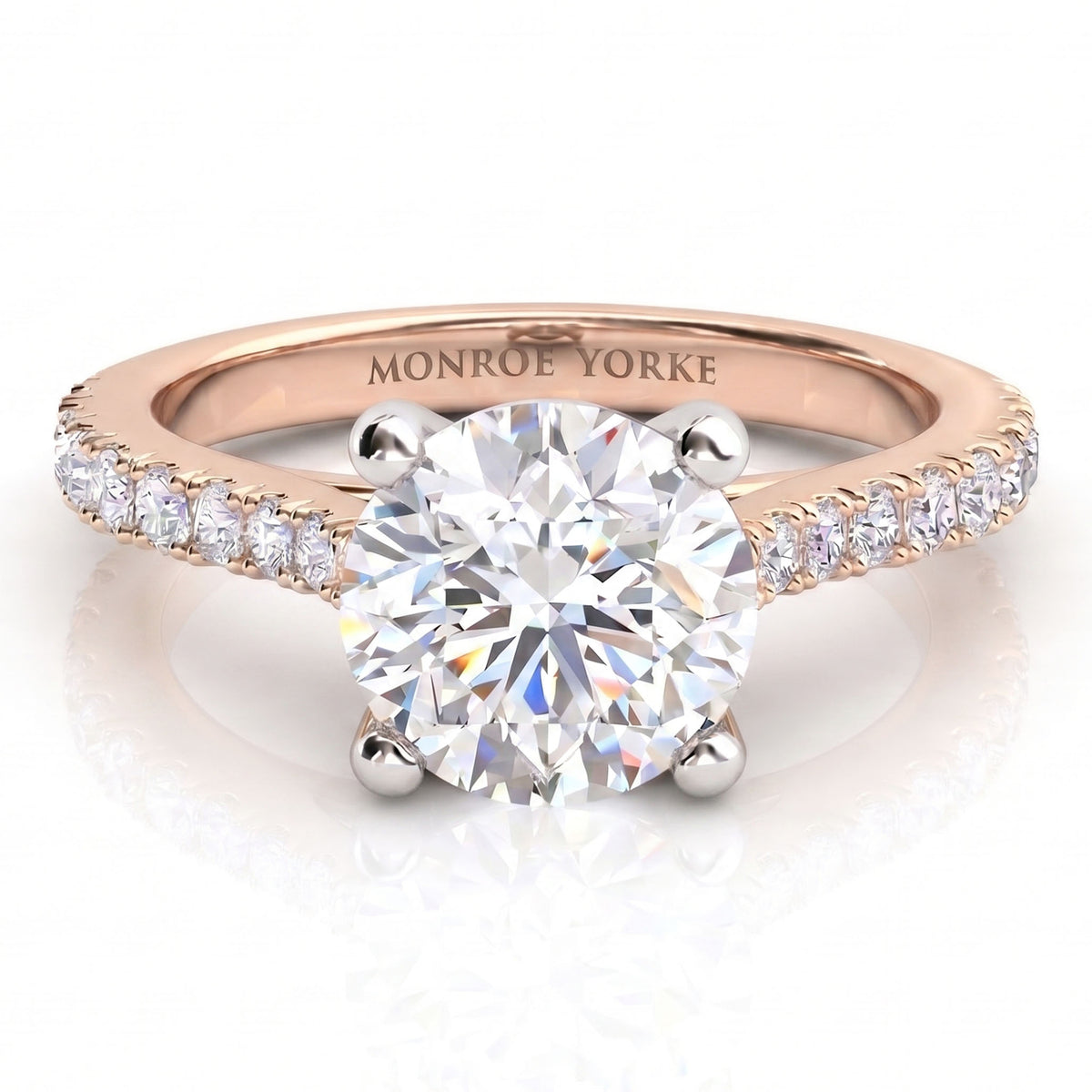 Enya rose gold engagement ring, round centre diamond with micro claw set diamonds along the shoulders, Monroe Yorke engraved on the band.