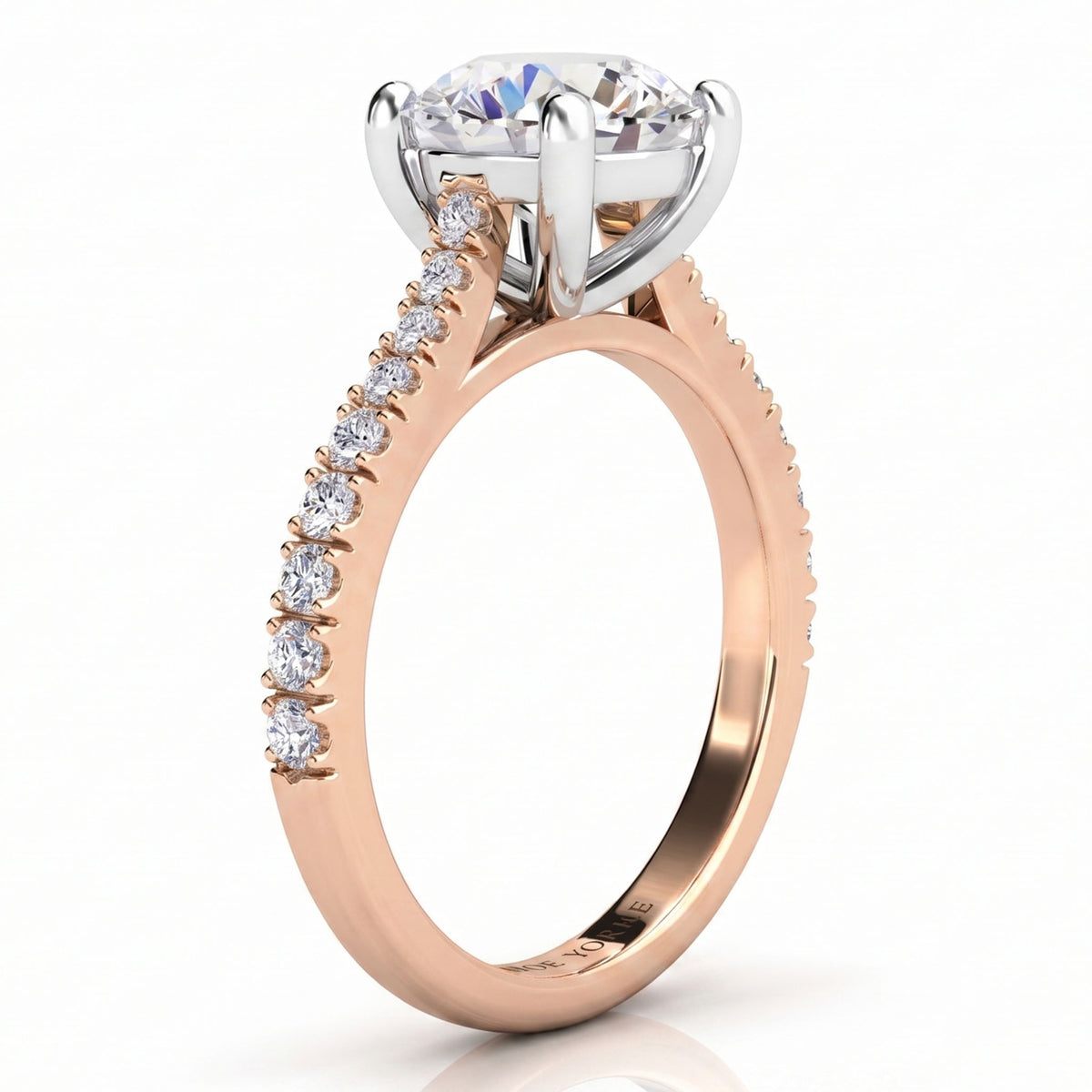 Enya rose gold engagement ring, round centre diamond and a row of micro claw set diamonds along the shoulder.