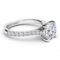 Enya engagement ring in white gold or platinum, side view of the four claw setting and the diamonds on the sweep up band.