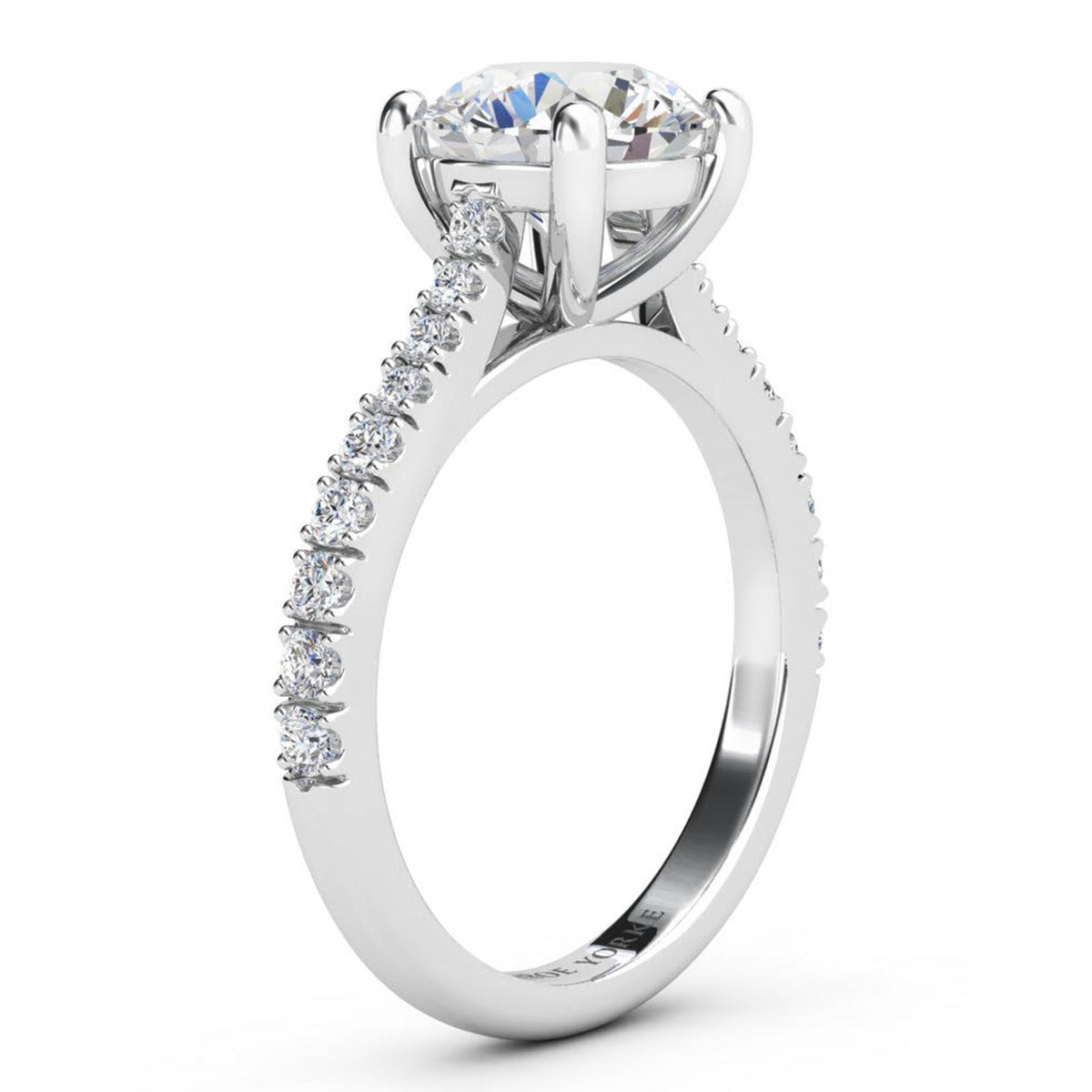 Enya engagement ring in white gold or platinum, profile view of the four claw setting and the sweep up band.