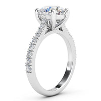 Enya engagement ring in white gold or platinum, profile view of the four claw setting and the sweep up band.