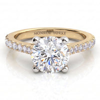 Enya yellow gold engagement ring, round brilliant centre diamond in a four claw head with micro claw set diamonds along the shoulders.
