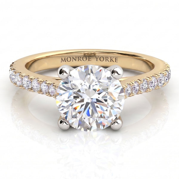 Enya yellow gold engagement ring, round brilliant centre diamond in a four claw head with micro claw set diamonds along the shoulders.