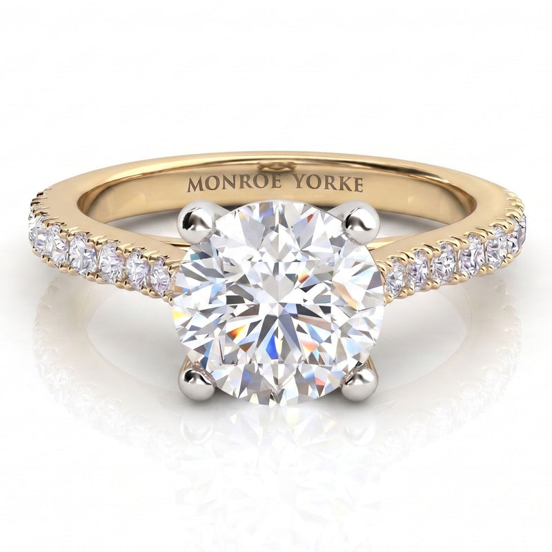 Enya yellow gold engagement ring, round brilliant centre diamond in a four claw head with micro claw set diamonds along the shoulders.