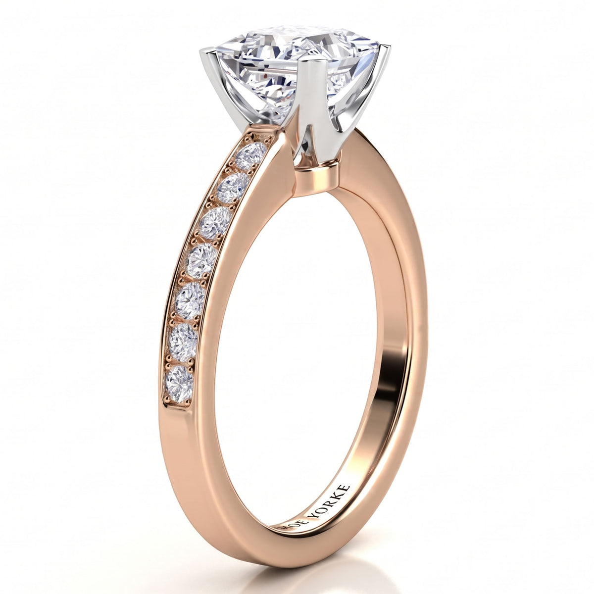 Fifth Avenue rose gold engagement ring, princess cut centre diamond and a row of micro claw set diamonds along the band.