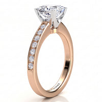Fifth Avenue rose gold engagement ring, princess cut centre diamond and a row of micro claw set diamonds along the band.