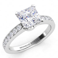 Fifth Avenue engagement ring in white gold or platinum, top view of the princess cut centre diamond and the diamond set band.