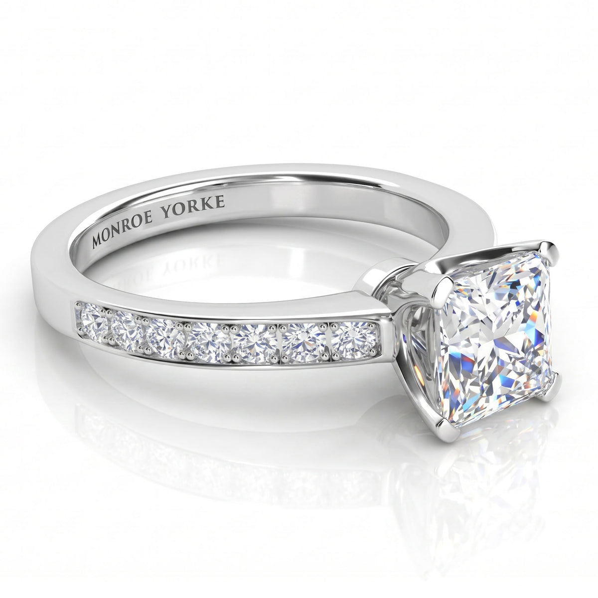 Fifth Avenue engagement ring in white gold or platinum, side view showing the micro claw set shoulder diamonds.
