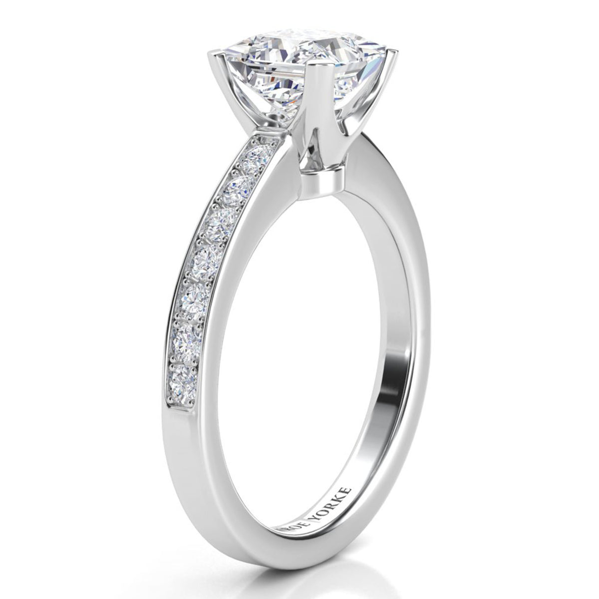 Fifth Avenue engagement ring in white gold or platinum, side view of the princess cut centre diamond in its four claw head.
