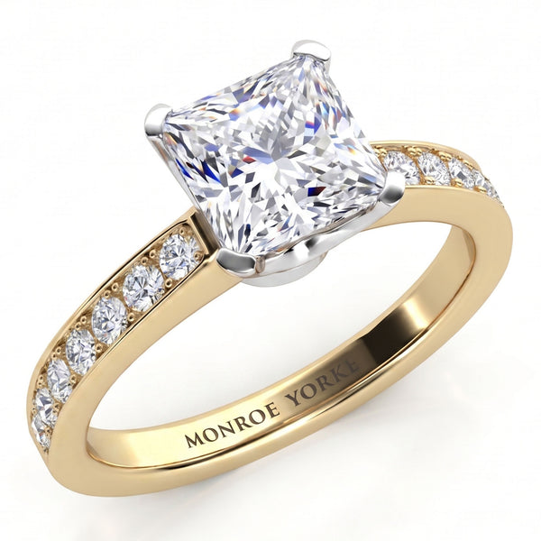 Fifth Avenue yellow gold engagement ring, princess cut centre diamond with micro claw set diamonds along the band, Monroe Yorke engraved inside the band.