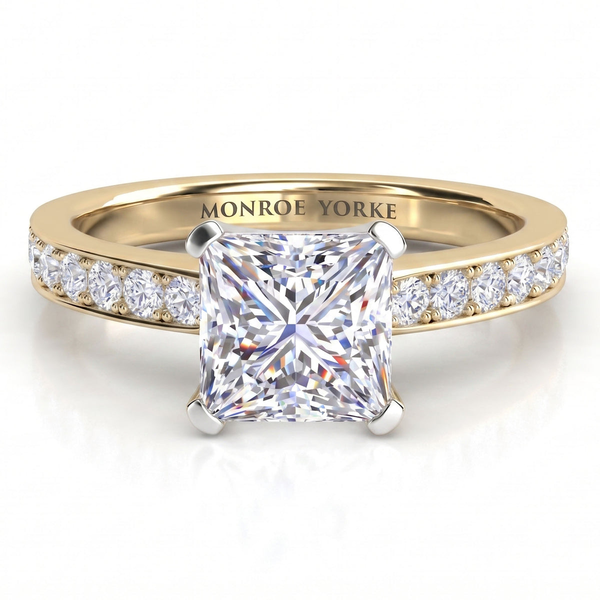 Fifth Avenue yellow gold engagement ring, princess cut centre diamond with micro claw set diamonds on the shoulders.