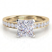 Fifth Avenue yellow gold engagement ring, princess cut centre diamond with micro claw set diamonds on the shoulders.