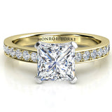 Fifth Avenue Princess cut diamond ring in gold. Centre square princess cut diamond with pave set diamonds on the band. 
