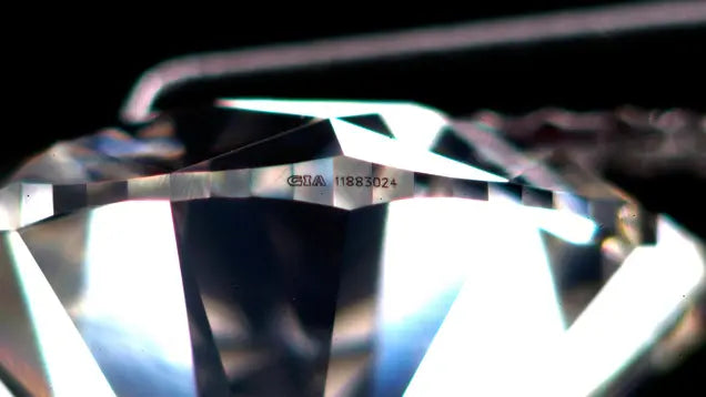 GIA laser inscription of the diamond certificate number on a diamond girdle