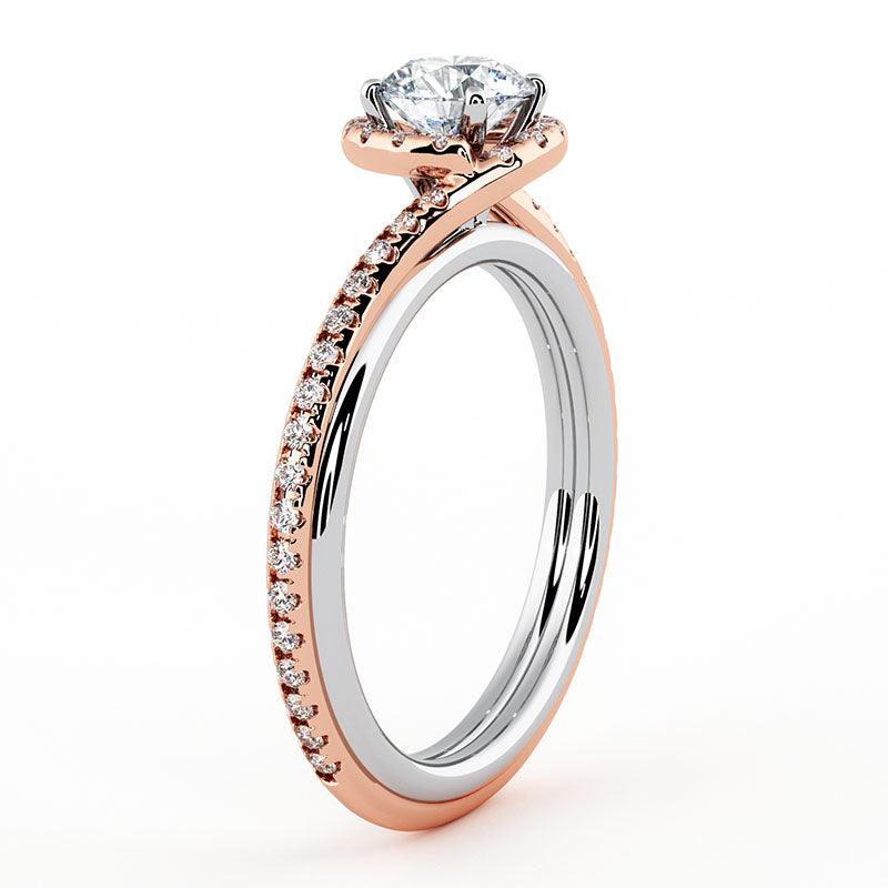 Gale two-tone halo engagement ring in rose gold, angled view of the pave shoulders and halo