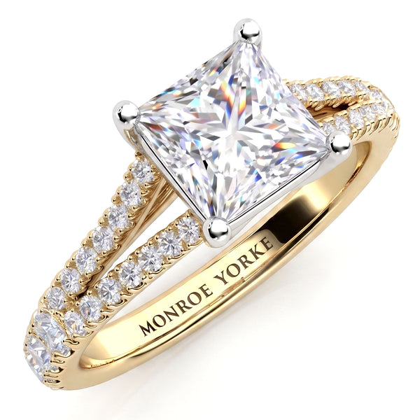 A princess-cut diamond engagement ring with a yellow gold split band accented by pavé set diamonds, 