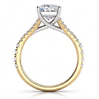 A two-tone diamond engagement ring featuring a yellow gold band with pavé-set clear stones and a silver-coloured cross over setting holding a princess cut centre stone, shown on a white background.