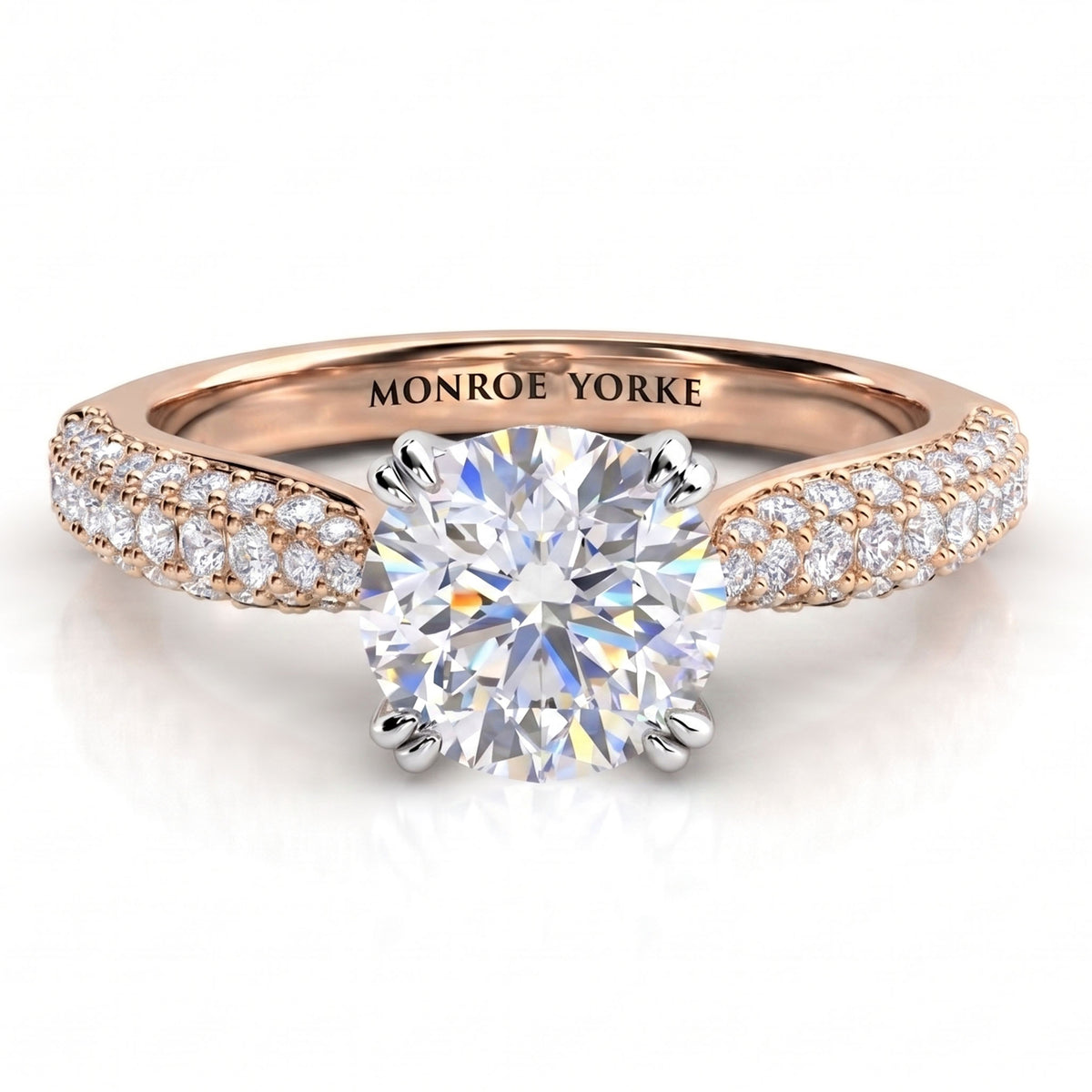 A rose gold diamond ring with a round-cut center stone and pavé-set diamonds along the shoulders.