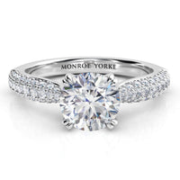 Harper - diamond engagement ring with a centre ound diamond in a double claw setting.  A curved band with 3 rows of pave set diamonds. white gold or platinum 