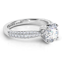 Side view of Harper ring showing the curved band of pave set diamonds.  It has 3 rows of diamonds. White gold or platinum. 