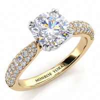 Harper - A Monroe Yorke engagement ring featuring a large round brilliant-cut clear center stone in a silver-colored setting, with a yellow gold band accented by 3 rows of pavé-set diamonds