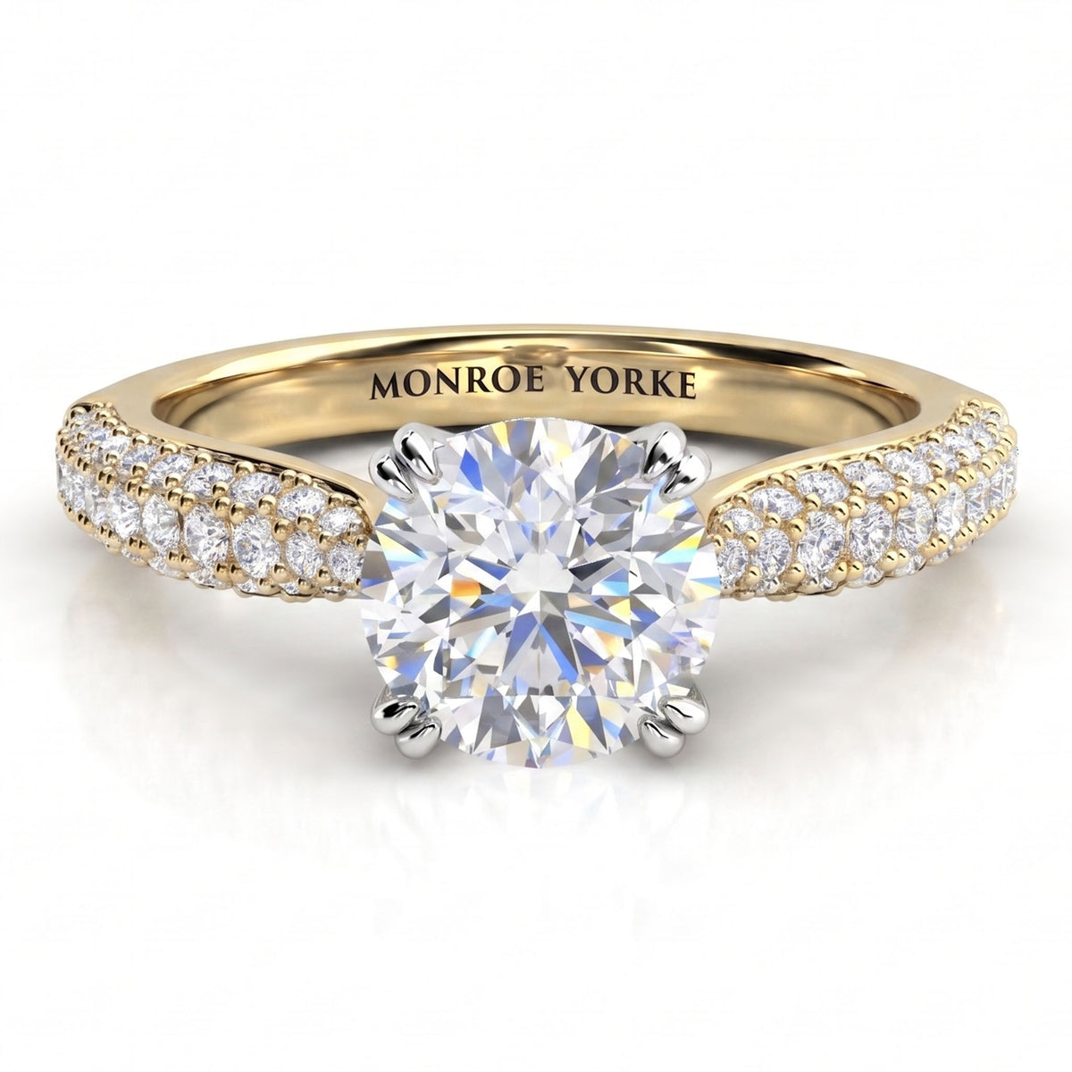 Harper - A yellow gold solitaire engagement ring with a round brilliant-cut center diamond and pavé-set diamonds along the shoulders.