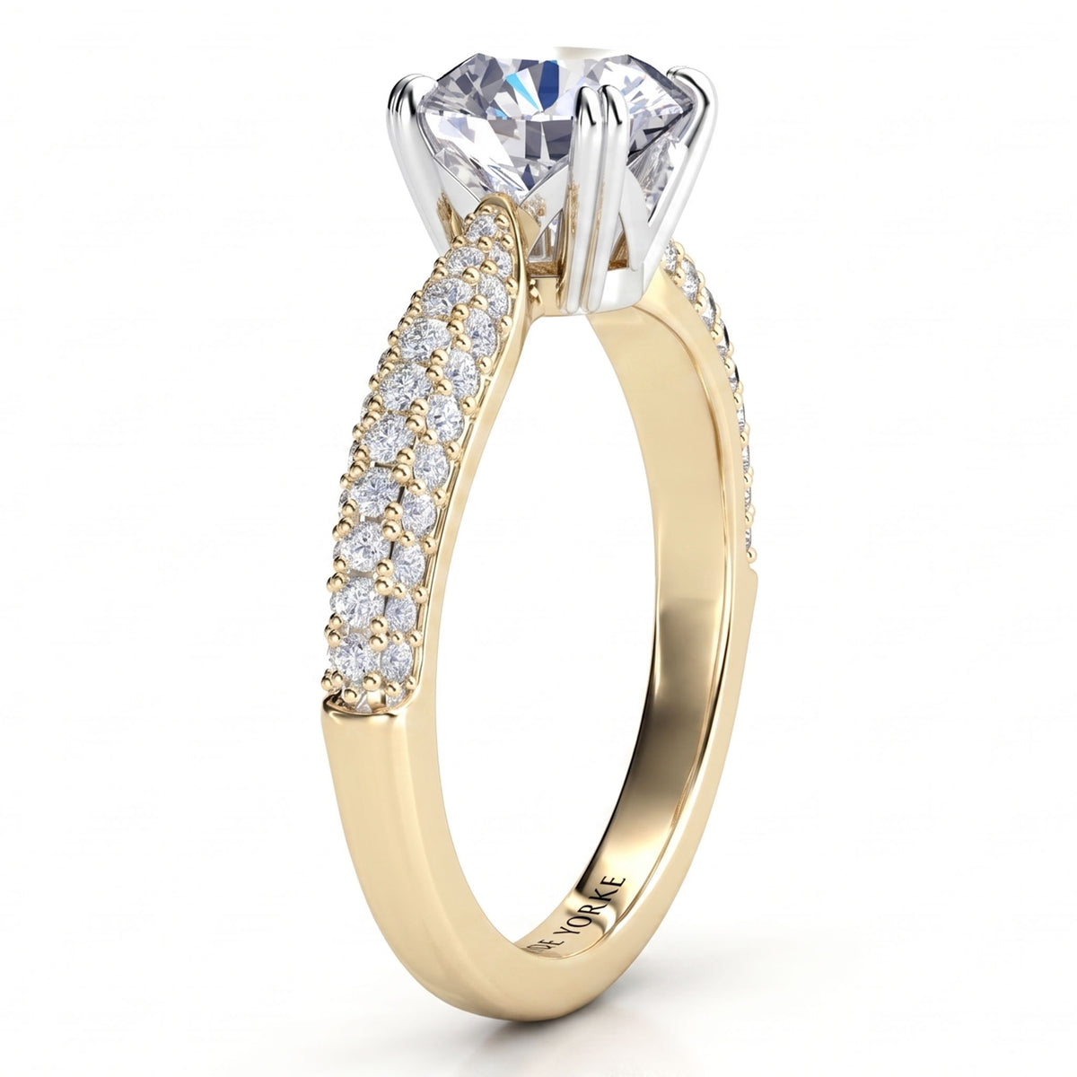 Harper - A yellow gold solitaire engagement ring with a large round-cut clear center stone and a pavé-set curved band of pave set diamonds