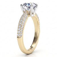 Harper - A yellow gold solitaire engagement ring with a large round-cut clear center stone and a pavé-set curved band of pave set diamonds