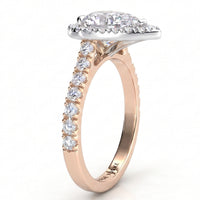 A rose gold engagement ring featuring a large pear centre stone in a halo setting, with a channel-set row of round diamonds along the shank.