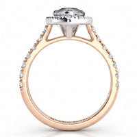 A rose gold engagement ring featuring a pear-cut clear centre stone in a halo setting, with small pavé-set clear stones along the shank.