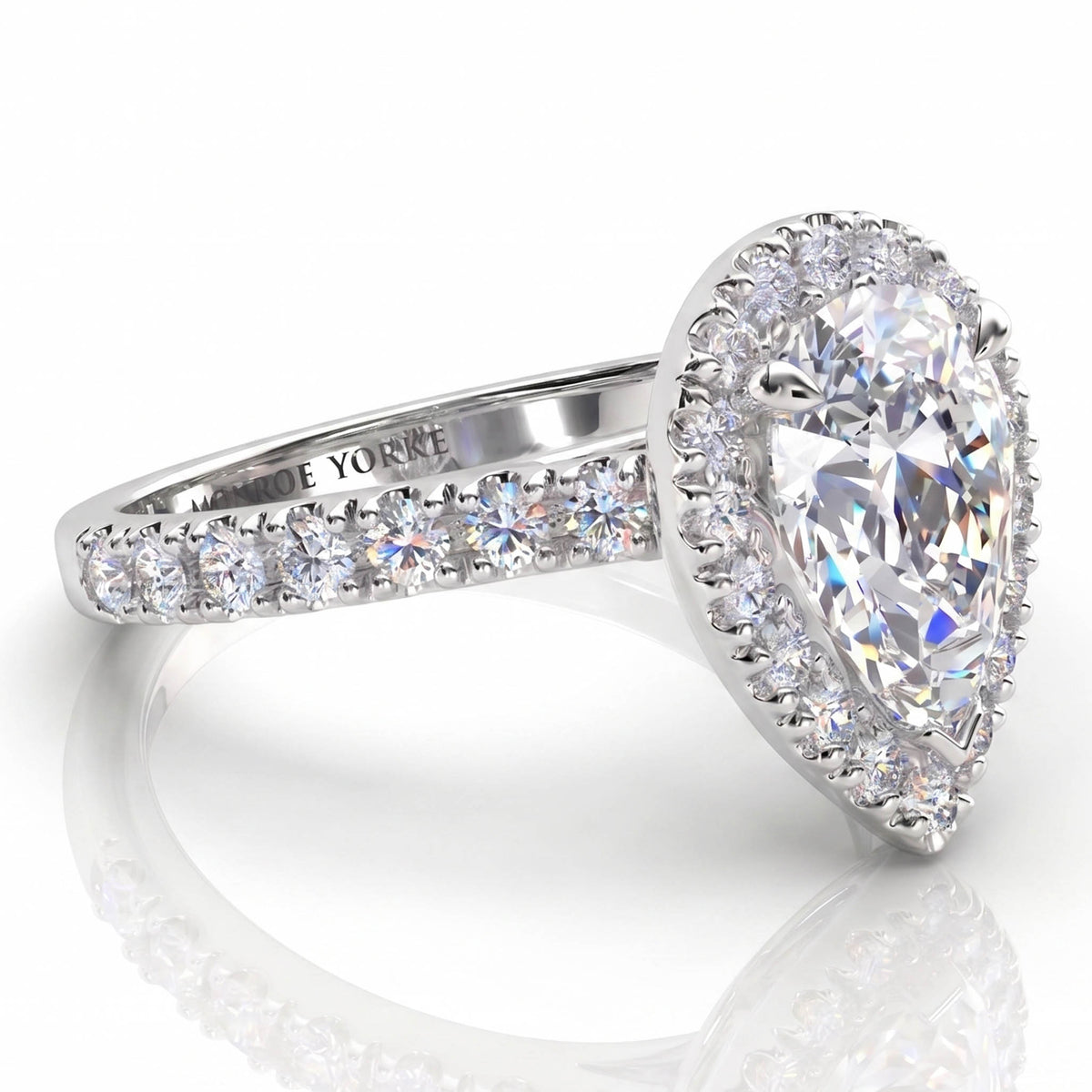 Iris - Platinum GIA certified pear cut diamond halo engagement ring.  Side view showing diamonds on the sweep up band. Also available in white gold