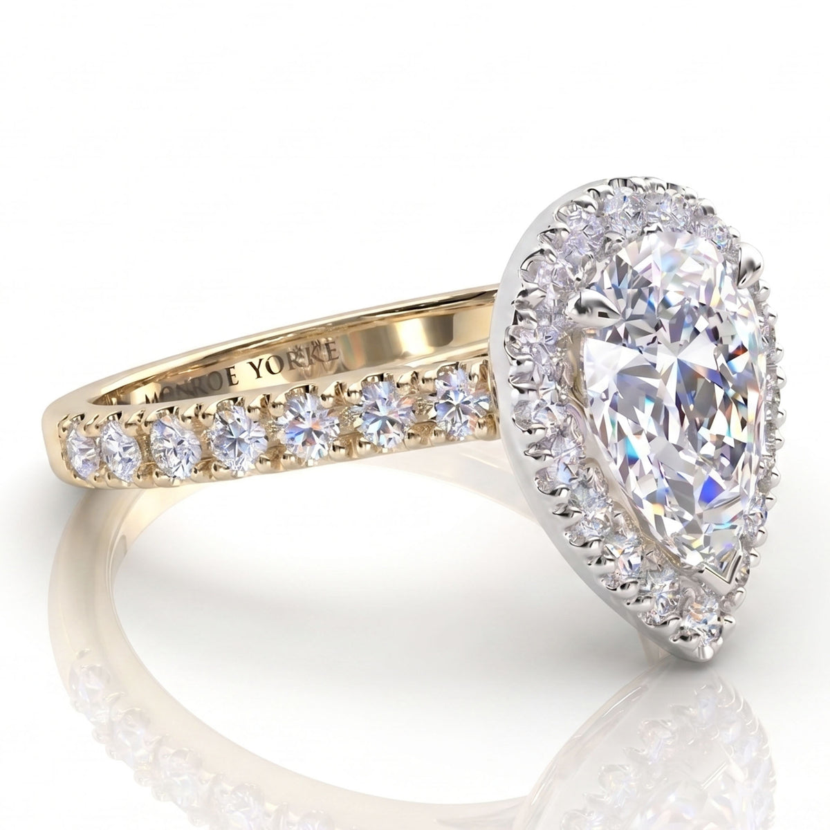 Iris - yellow gold GIA certified pear cut diamond halo engagement ring.  Side view showing diamonds on the sweep up band. 