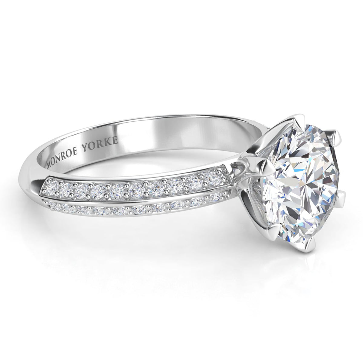 Juliet engagement ring in platinum or white gold. Side view showing the six claw setting and the pave-set band.