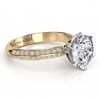 Juliet engagement ring in yellow gold. Knife edge band with pave-set diamonds either side of the six claw centre setting.