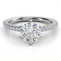 June - White gold or platinum, six claw centre setting with diamonds on the band.  Centre GIA certified round diamond. 