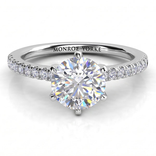 June - White gold or platinum, six claw centre setting with diamonds on the band.  Centre GIA certified round diamond. 