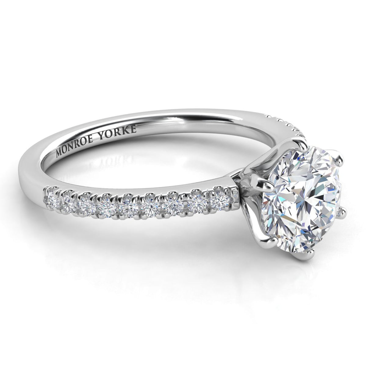 Diamond engagement ring with Side diamonds. Centre six claw setting. White gold or platinum