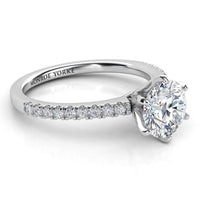 Diamond engagement ring with Side diamonds. Centre six claw setting. White gold or platinum